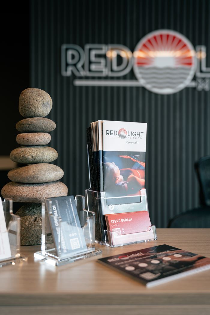 The front desk close up, with brochures, business cards and a stacked stone cairn.